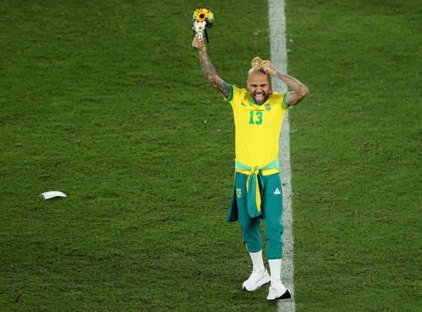 Gold medalist Dani Alves of Team Brazil celebrates with his gold medal during the Men's Football Competition Medal Ceremony on day fifteen of the...