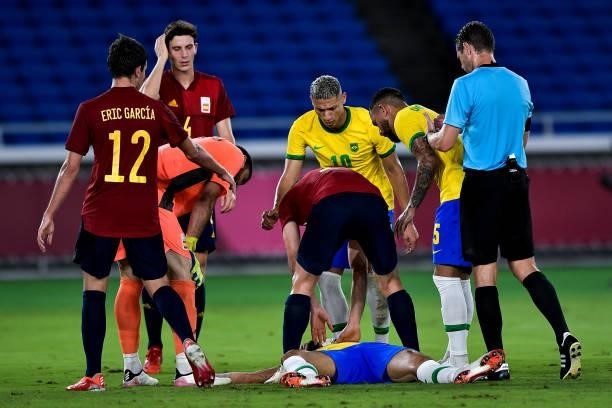 Matheus Cunha of Brazil lies on the ground after a collision with Unai Simon of Spain during the Tokyo 2020 Olympic Mens Football Tournament Gold...