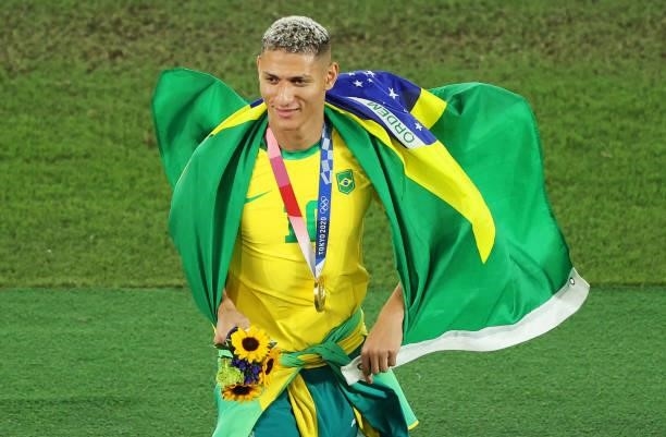 Gold medalist Richarlison of Team Brazil reacts with his gold medal during the Men's Football Competition Medal Ceremony on day fifteen of the Tokyo...