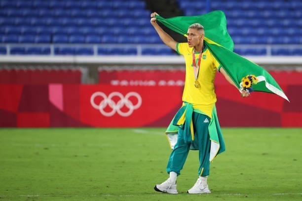 Richarlison of Team Brazil celebrates during the medal ceremony after defeating Team Spain 2-1 to win the men's gold medal match between Team Brazil...