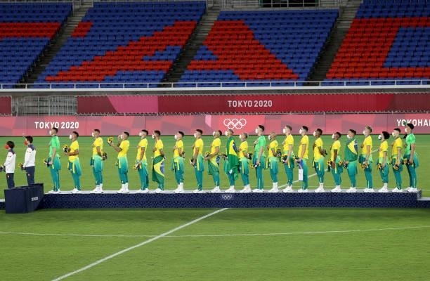 Gold medalists of Team Brazil stand for the national anthem on the podium with their gold medals during the Men's Football Competition Medal Ceremony...