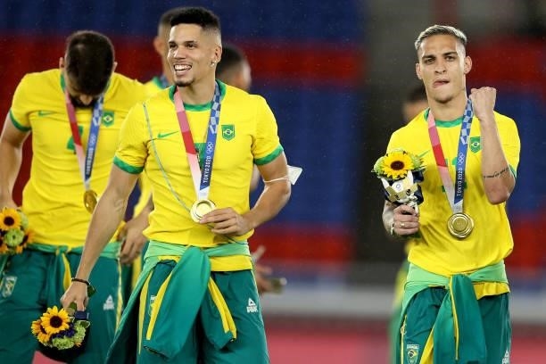 Gold medalists Paulinho and Antony of Team Brazil celebrate with their gold medals during the Men's Football Competition Medal Ceremony on day...