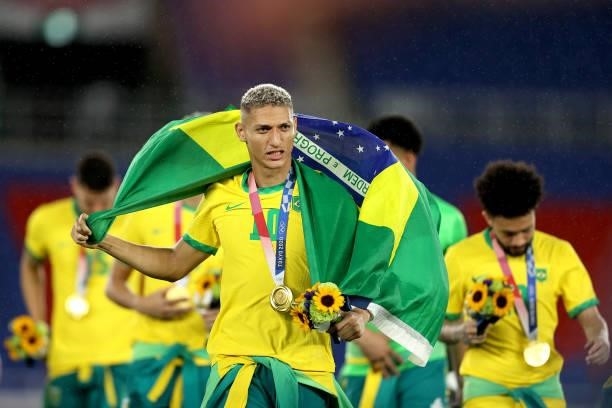 Gold medalist Richarlison of Team Brazil celebrates with their gold medal during the Men's Football Competition Medal Ceremony on day fifteen of the...