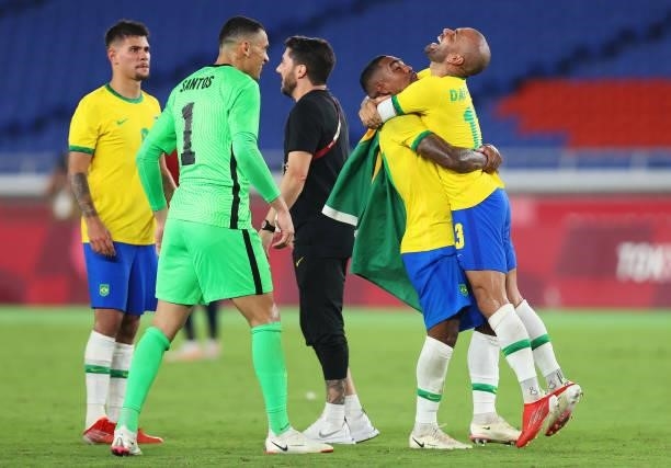 Dani Alves of Team Brazil celebrates their side's victory with Malcom after the Men's Gold Medal Match between Brazil and Spain on day fifteen of the...