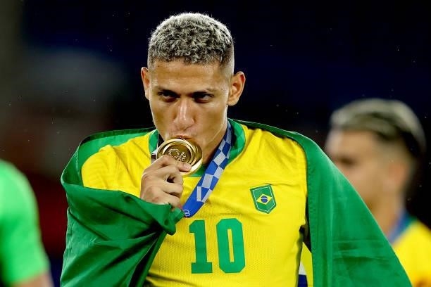 Gold medalist Richarlison of Team Brazil celebrates with their gold medal during the Men's Football Competition Medal Ceremony on day fifteen of the...