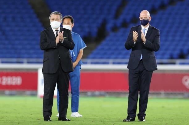 Khozo Tashima, President of Japan Football Association and Gianni Infantino, President of FIFA wear face masks as they look on during the Men's...