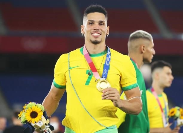 Gold medalist Paulinho of Team Brazil celebrates with their gold medal during the Men's Football Competition Medal Ceremony on day fifteen of the...
