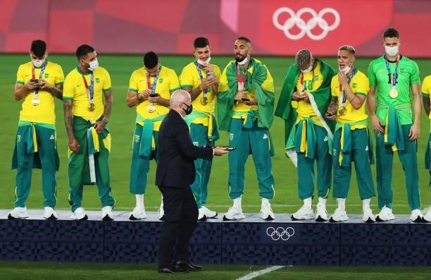 Gianni Infantino, President of FIFA hands out gold medals to the players of Team Brazil during the Men's Football Competition Medal Ceremony on day...