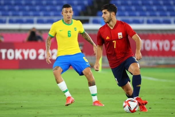 Marco Asensio of Team Spain controls the ball against Guilherme Arana of Team Brazil in the first half during the men's gold medal match between Team...