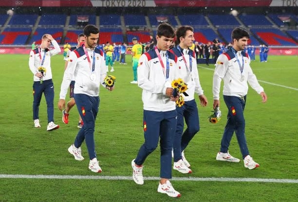 Silver medalists of Team Spain react as they leave the pitch after being awarded with their silver medals during the Men's Football Competition Medal...