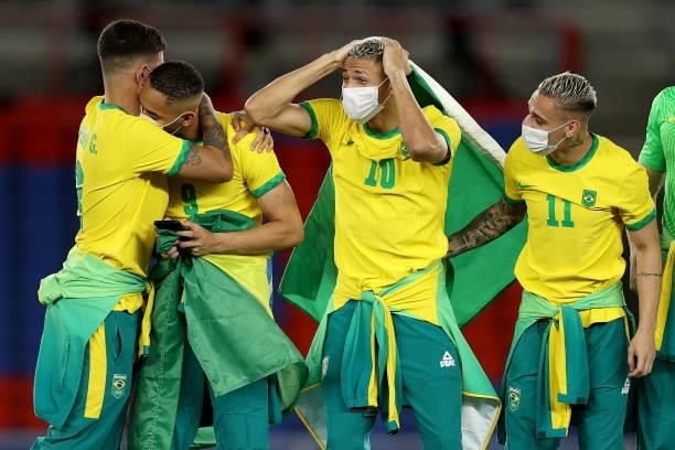 Gold medalists Richarlison and Antony of Team Brazil react on the podium during the Men's Football Competition Medal Ceremony on day fifteen of the...