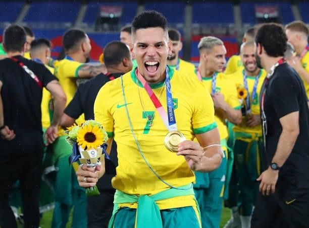 Gold medalist Paulinho of Team Brazil celebrates with their gold medal during the Men's Football Competition Medal Ceremony on day fifteen of the...
