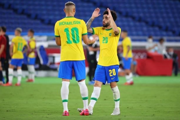 Richarlison and Claudinho of Team Brazil react in the first half during the men's gold medal match between Team Brazil and Team Spain at...