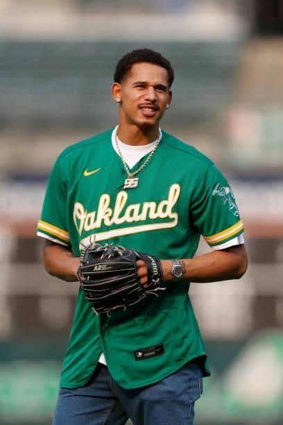 Player Juan Toscano-Anderson of the Golden State Warriors prepares to throw out the ceremonial first pitch before the game between the Oakland...