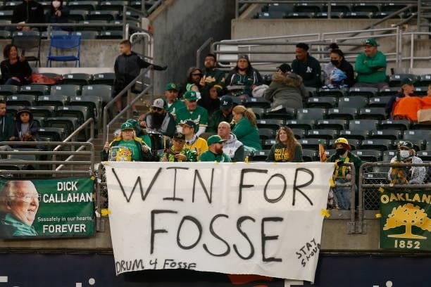 Sign in support of broadcaster Ray Fosse is displayed by fans during the game between the Oakland Athletics and the Texas Rangers at RingCentral...