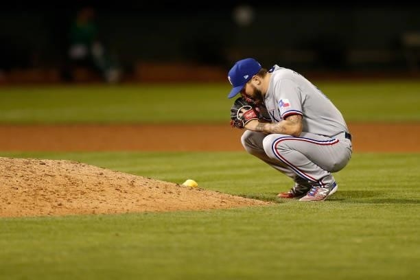 Joe Barlow of the Texas Rangers takes a moment behind the mound before pitching against the Oakland Athletics at RingCentral Coliseum on August 06,...