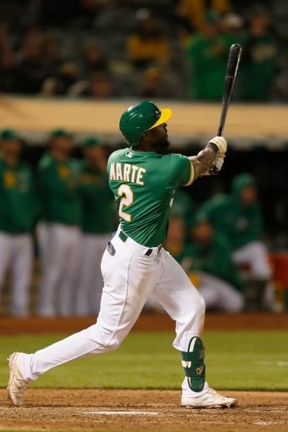 Starling Marte of the Oakland Athletics hits a walk-off three-run home run in the bottom of the eleventh inning against the Texas Rangers at...