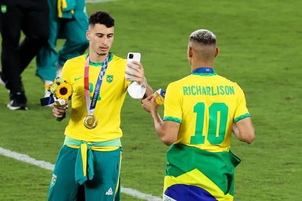 Richarlison and Gabriel Martinelli of Team Brazil celebrate after the award ceremony of the Men's Gold Medal Match between Team Brazil and Team Spain...