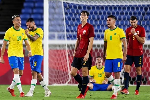 Reinier, Douglas Luiz, Bruno Guimaraes of Team Brazil celebrate the victory after the Men's Gold Medal Match between Team Brazil and Team Spain on...