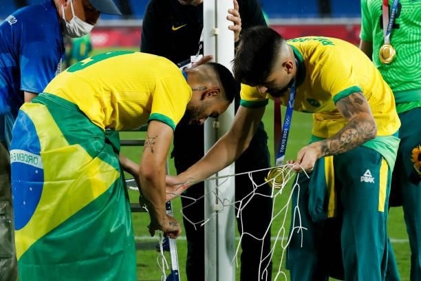 Matheus Cunha and Ricardo Graca of Brazil cut the net to celebrate after the award ceremony of the Men's Gold Medal Match between Brazil and Spain on...