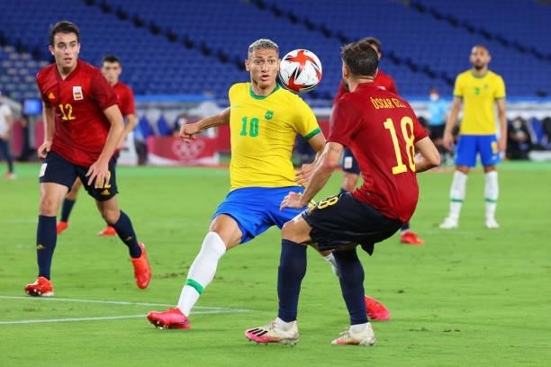 Richarlison of Team Brazil and Oscar Gil of Team Spain follow the ball in the first half during the men's gold medal match between Team Brazil and...