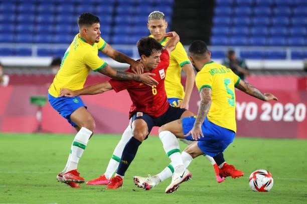 Martin Zubimendi of Team Spain battles for possession against Bruno Guimaraes , Richarlison and Luiz Douglas of Team Brazil in the second half during...