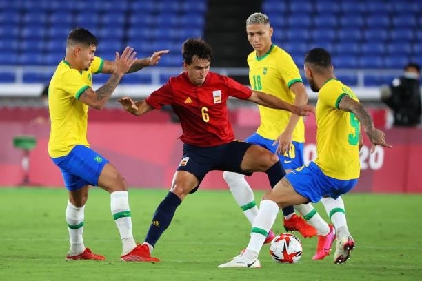 Martin Zubimendi of Team Spain battles for possession against Bruno Guimaraes , Richarlison and Luiz Douglas of Team Brazil in the second half during...