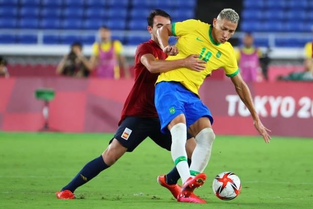 Richarlison of Team Brazil and Bryan Gil of Team Spain battle for possession in the second half during the men's gold medal match between Team Brazil...