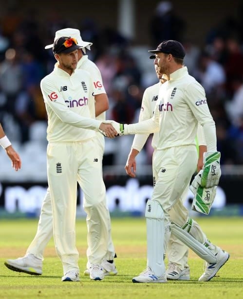 Joe Root of England shakes hands with Jos Buttler at the end of play during day four of the First LV= Insurance test match between England and India...