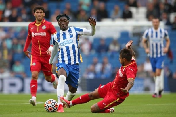 Yves Bissouma of Brighton & Hove Albion is tackled by Damian Suarez of Getafe during the Pre-Season Friendly match between Brighton & Hove Albion and...