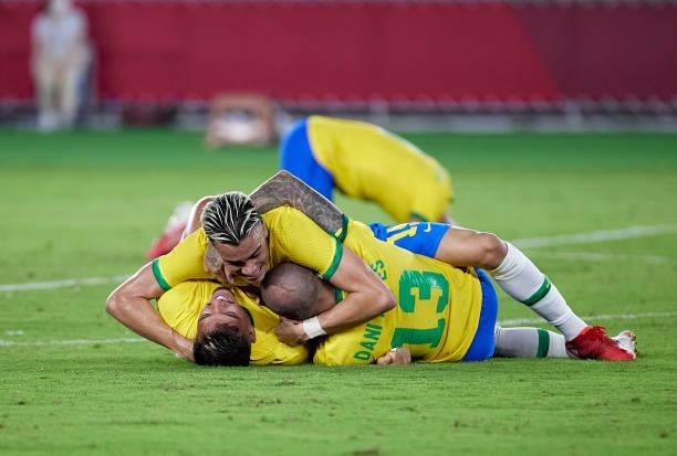 Reinier Jesus Carvalho, Gabriel Menino and Dani Alves of Team Brazil celebrate after defeating Team Spain during the men's gold medal match between...