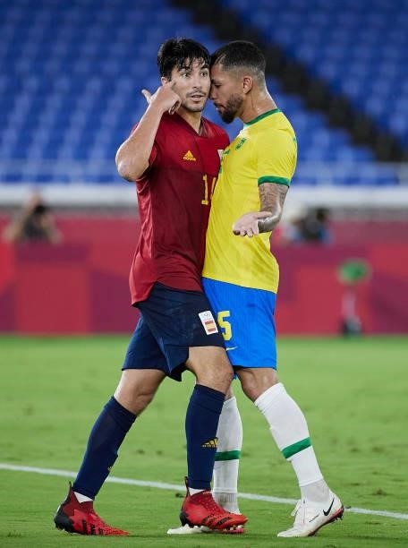 Douglas Luiz of Team Brazil argues with Carlos Soler of Team Spain during the Men's Gold Medal Match between Team Brazil and Team Spain on day...