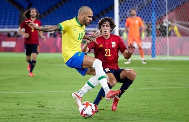Daniel Alves of Team Brazil competes for the ball with Bryan Gil of Team Spain during the Men's Gold Medal Match between Team Brazil and Team Spain...