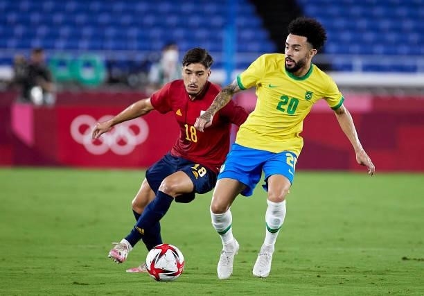 Claudinho Rodrigues of Team Brazil runs with the ball under pressure from Oscar Garcia of Team Spain during the Men's Gold Medal Match between Team...