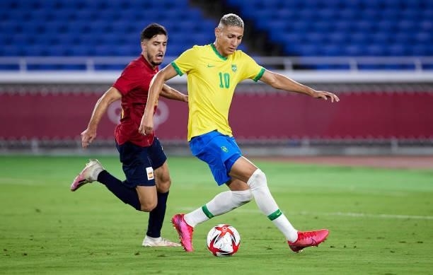 Richarlison De Andrade of Team Brazil runs with the ball under pressure from Oscar Garcia of Team Spain during the Men's Gold Medal Match between...