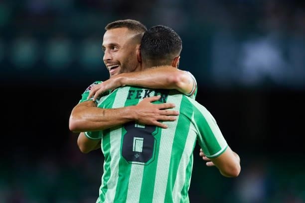 Nabil Fekir of Real Betis celebrates scoring a goal with Sergio Canales during a friendly match between Real Betis and AS Roma at Estadio Benito...