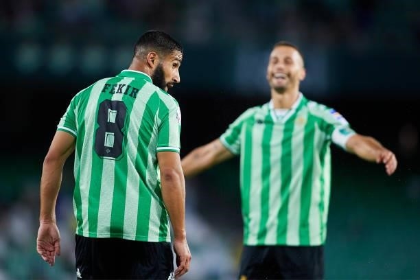 Nabil Fekir of Real Betis celebrates scoring a goal with Sergio Canales during a friendly match between Real Betis and AS Roma at Estadio Benito...