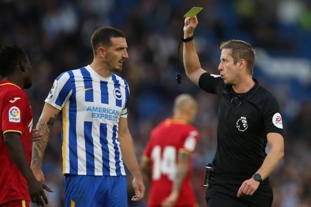 Lewis Dunk of Brighton & Hove Albion is shown a yellow card by the Referee during the Pre-Season Friendly match between Brighton & Hove Albion and...