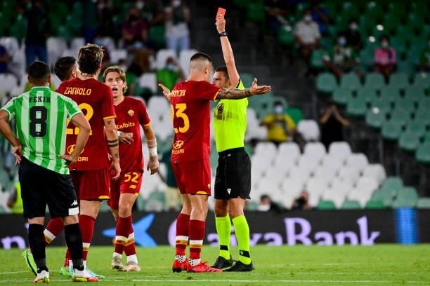 Gianluca Mancini of AS Roma is shown a red card by referee during the Unbeatables Cup at Estadio Benito Villamarin on August 07, 2021 in Seville,...