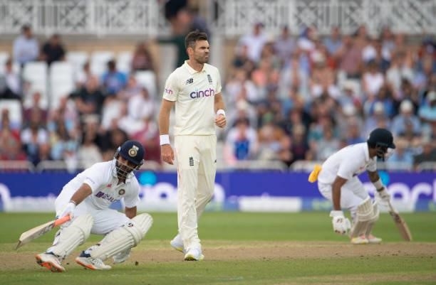 James Anderson of England and Rishabh Pant and KL Rahul of India during day two of the First Test Match between England and India at Trent Bridge on...