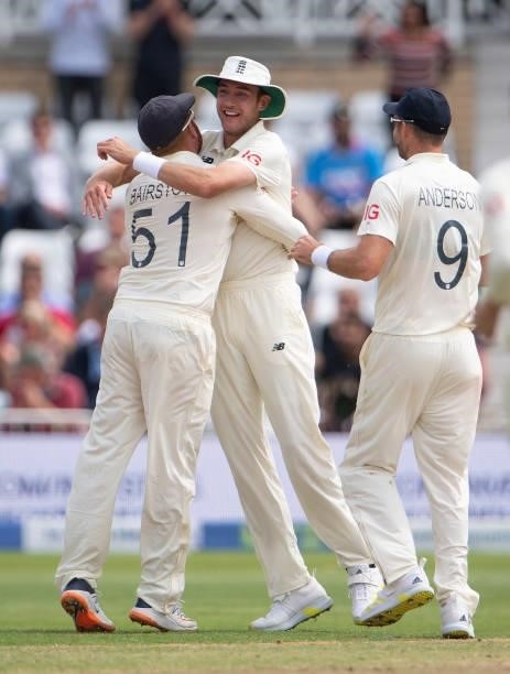 Jonny Bairstow of England celebrates with Stuart Broad after running out Ajinkya Rahane of India during day two of the First Test Match between...