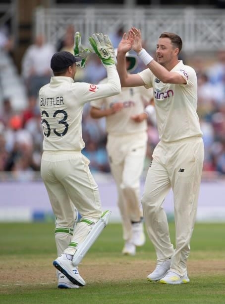 Ollie Robinson of England celebrates taking the wicket of Rohit Sharma of India with Jos Buttler during day two of the First Test Match between...