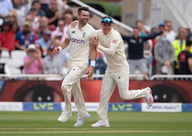 James Anderson of England celebrates taking the first ball wicket of Virat Kohli of India with Sam Curran during day two of the First Test Match...