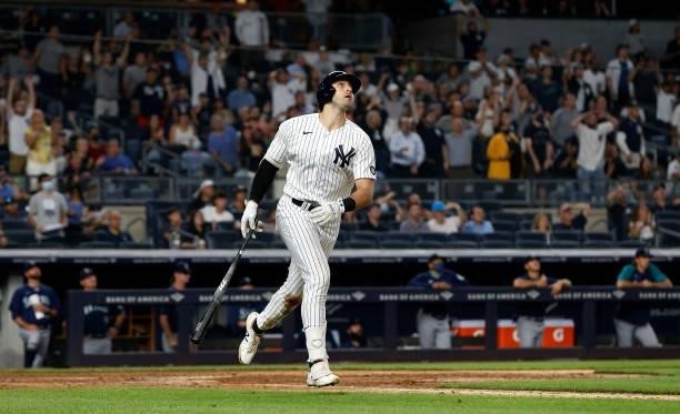 Joey Gallo of the New York Yankees follows through on his seventh inning three run home run against the Seattle Mariners at Yankee Stadium on August...
