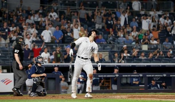 Joey Gallo of the New York Yankees follows through on his seventh inning three run home run against the Seattle Mariners at Yankee Stadium on August...