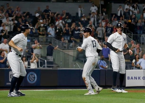Joey Gallo of the New York Yankees celebrates his seventh inning three run home run against the Seattle Mariners with teammates Giancarlo Stanton and...