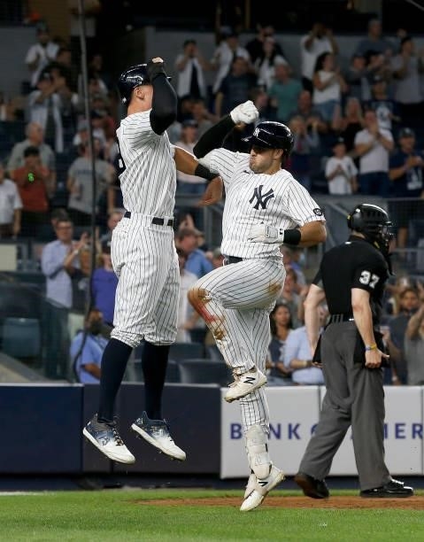 Joey Gallo of the New York Yankees celebrates his seventh inning three run home run against the Seattle Mariners with teammate Aaron Judge at Yankee...