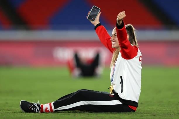 Gold medalist Janine Beckie of Team Canada poses with her gold medal during the Women's Football Competition Medal Ceremony after the Gold Medal...