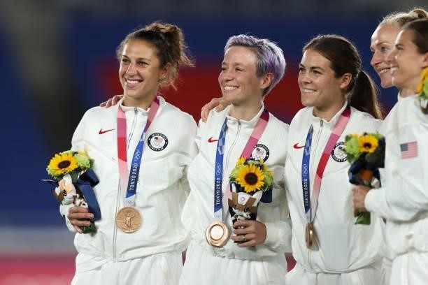 Bronze medalists Carli Lloyd , Megan Rapinoe and Kelley O'Hara of Team United States react with their bronze medal during the Women's Football...