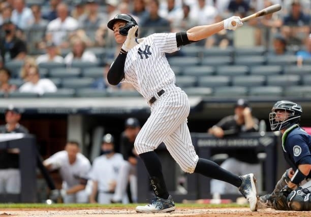 Aaron Judge of the New York Yankees follows through on his first inning home run against the Seattle Mariners at Yankee Stadium on August 07, 2021 in...